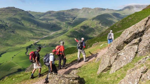 A group of walkers enjoying views over the valleys at Great Langdale